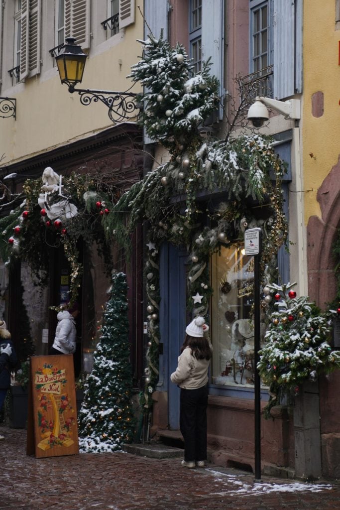 Christmas-decorated storefronts on Rue des Marchands