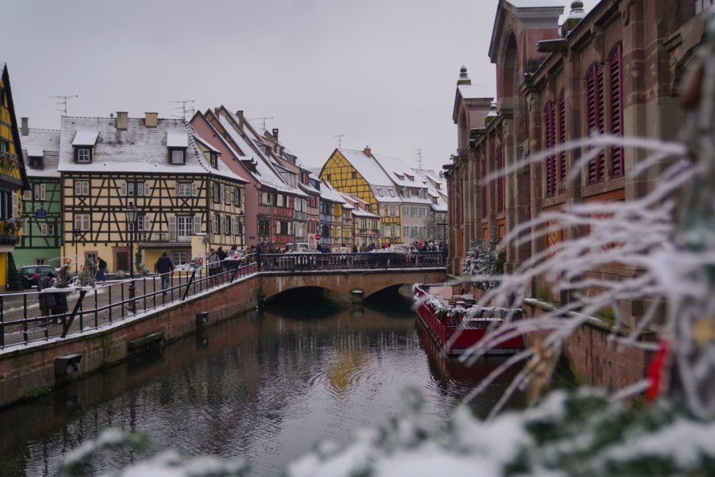 Snowy Petite Venise canal lined with half-timbered houses
