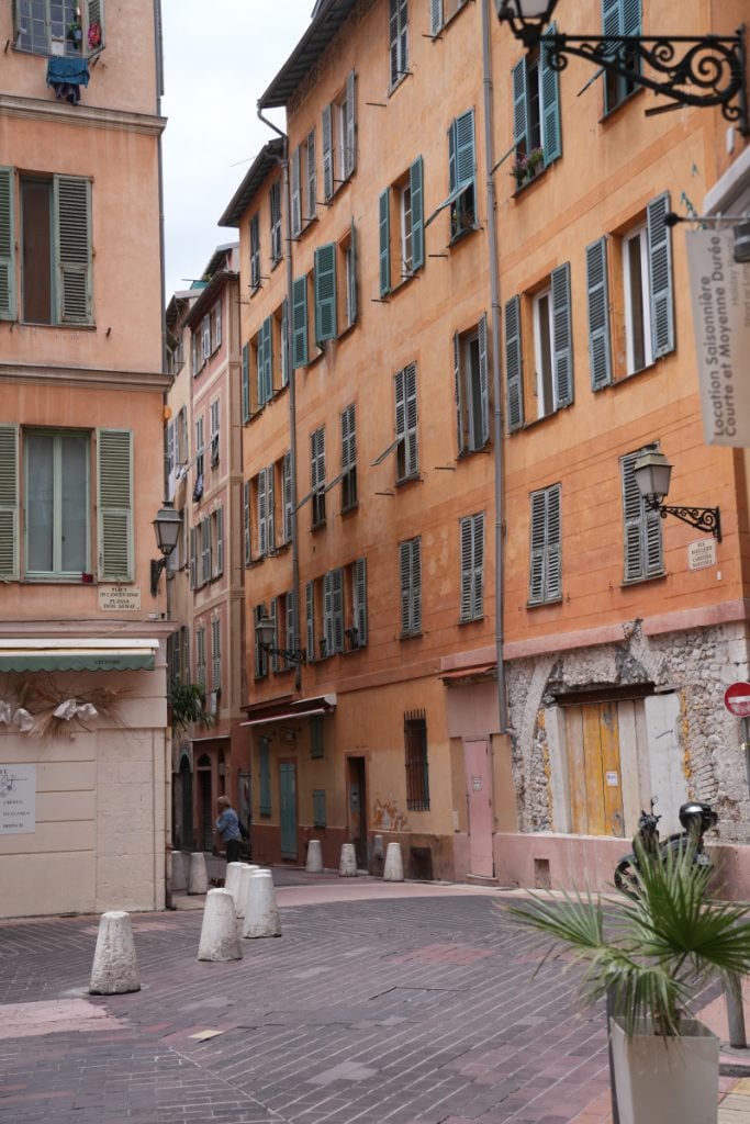Ochre buildings lining a narrow street in Nice's old town