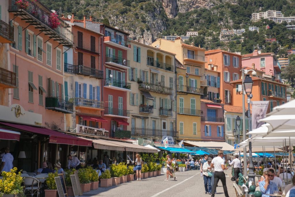 Colorful buildings and outdoor cafés along Quai de l'Amiral Courbet