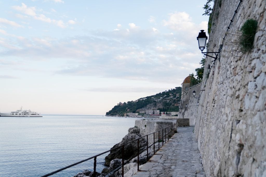 Sentier du Littoral path beside a stone wall and sea