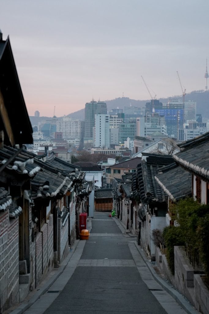 Hanok-lined street overlooking Seoul from Bukchon Village