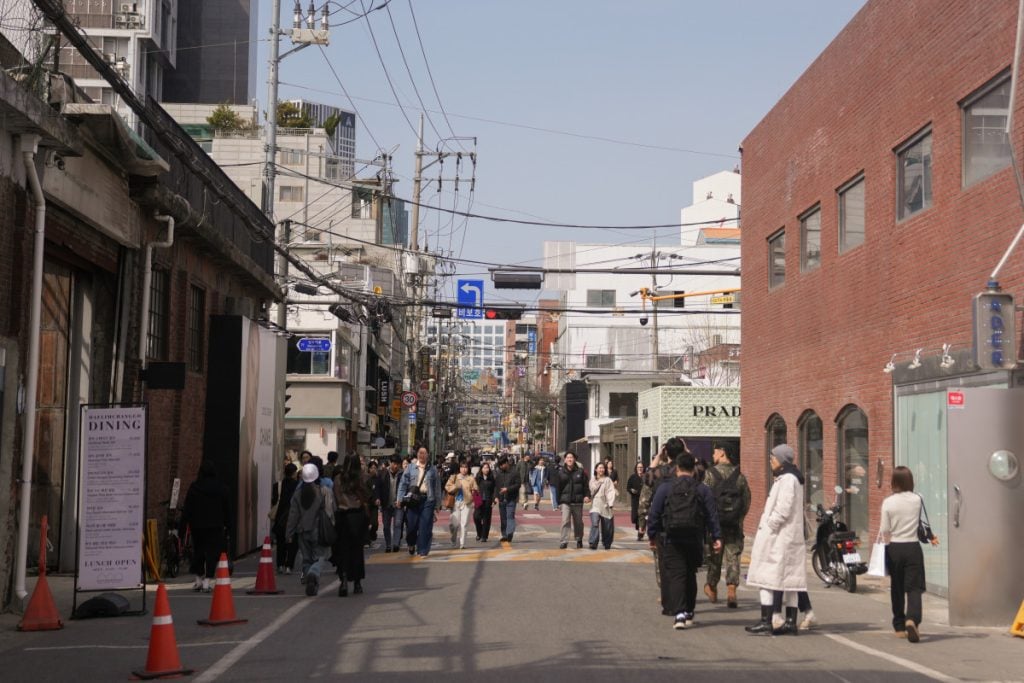Crowded street between brick buildings in Seongsu-dong