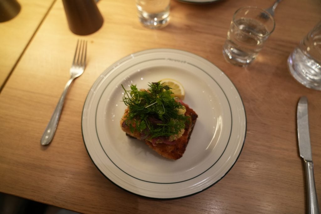 Close-up of herb-topped smørrebrød at Aamanns 1921