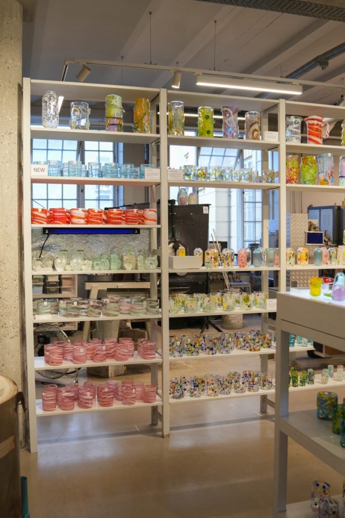 Colorful ceramics on shelves at Studio Arhoj