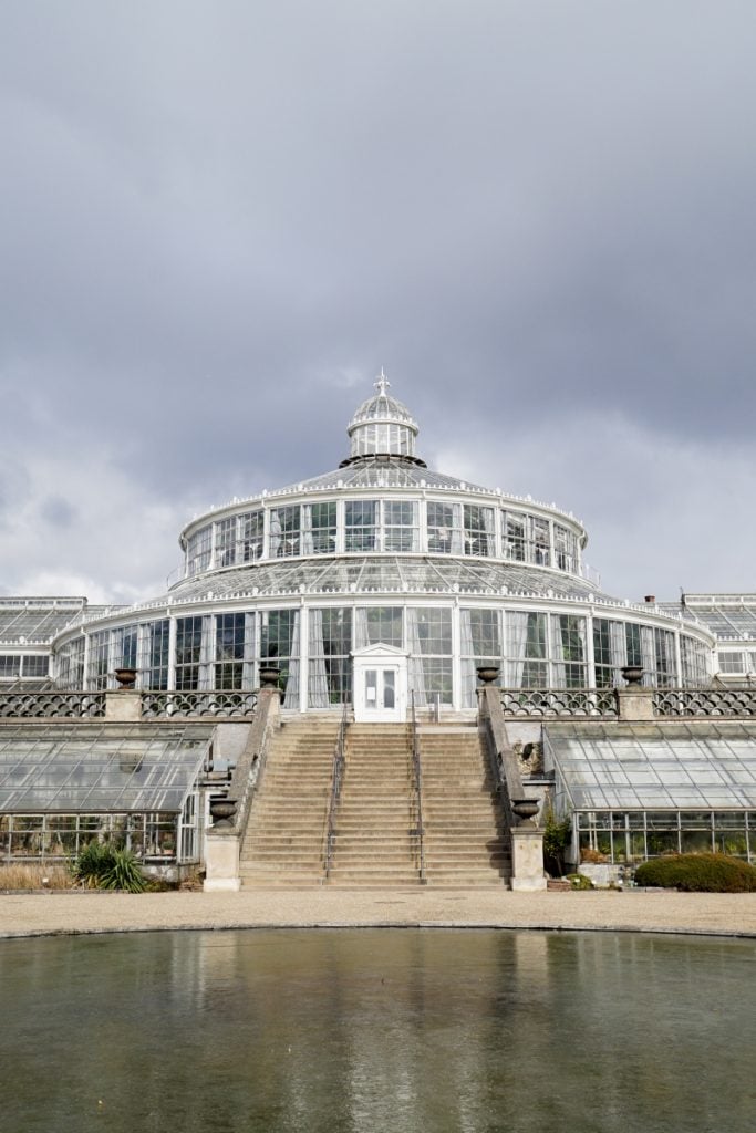 Glass Palm House and reflecting pool at Copenhagen Botanical Garden