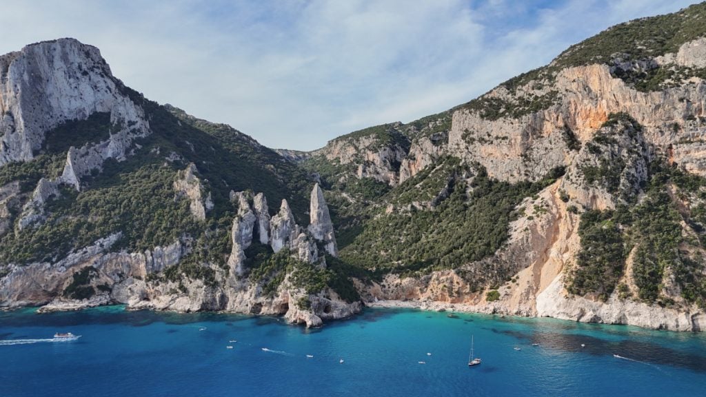 White pebble beach and natural rock arch at Cala Goloritzè