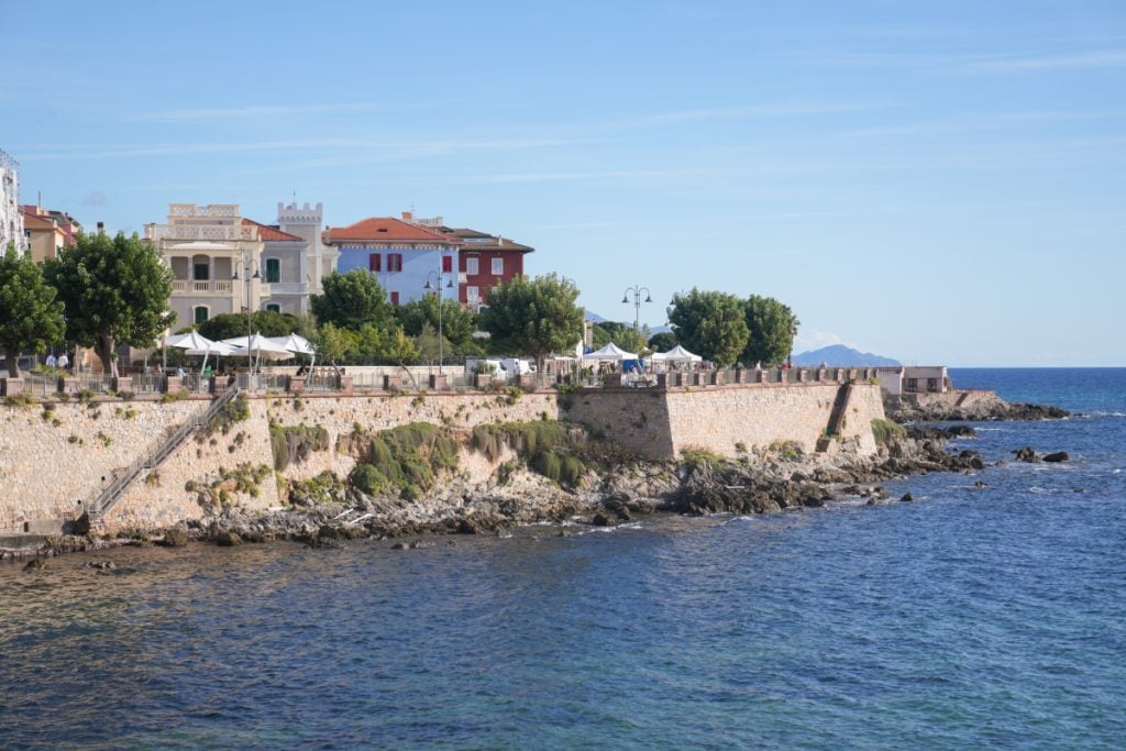 The rugged coastline of Alghero, Sardinia with clear water