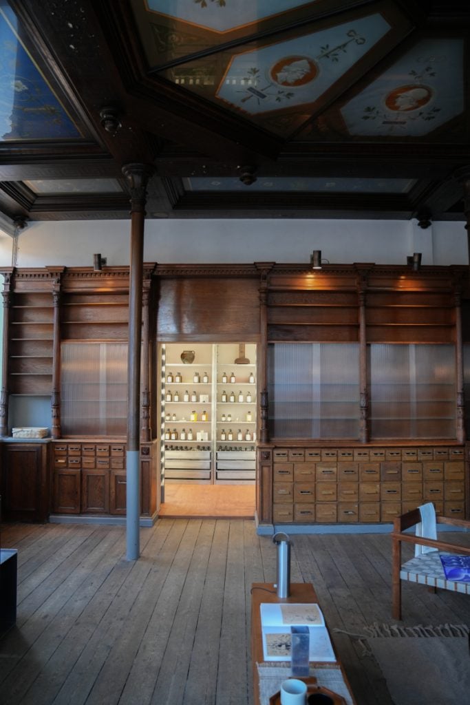 Floor-to-ceiling apothecary cabinets inside FRAMA Studio