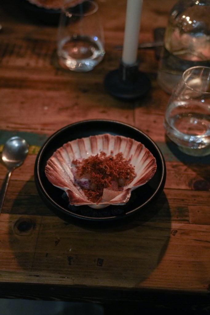 Scallop course served in a shell at Høst restaurant