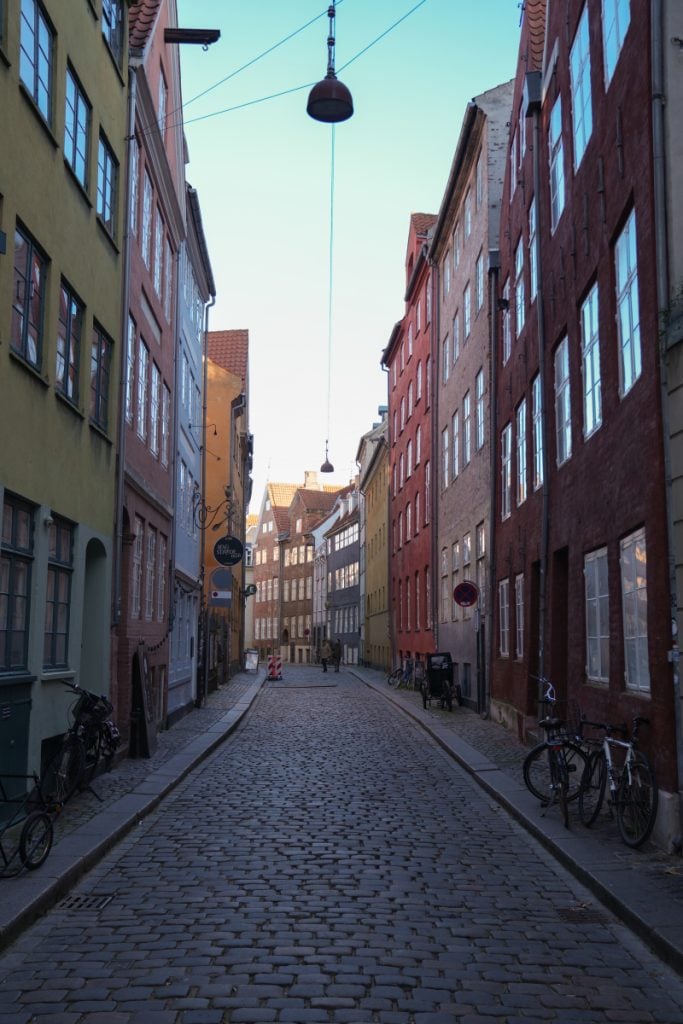 Cobblestone Magstræde lined with colorful historic buildings