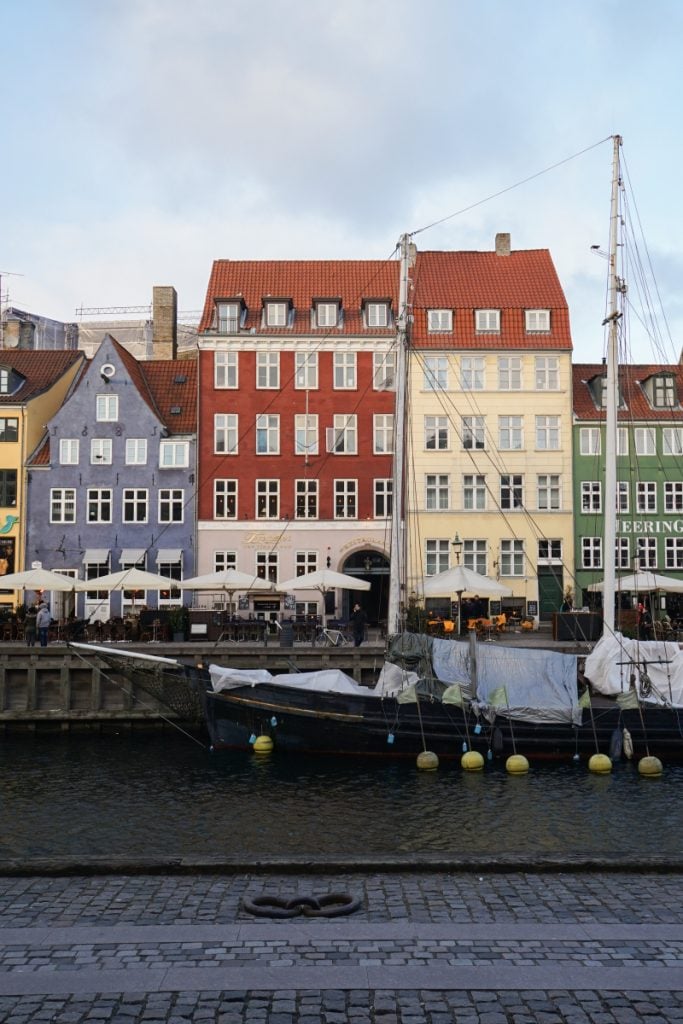 Colorful Nyhavn townhouses reflected in the canal