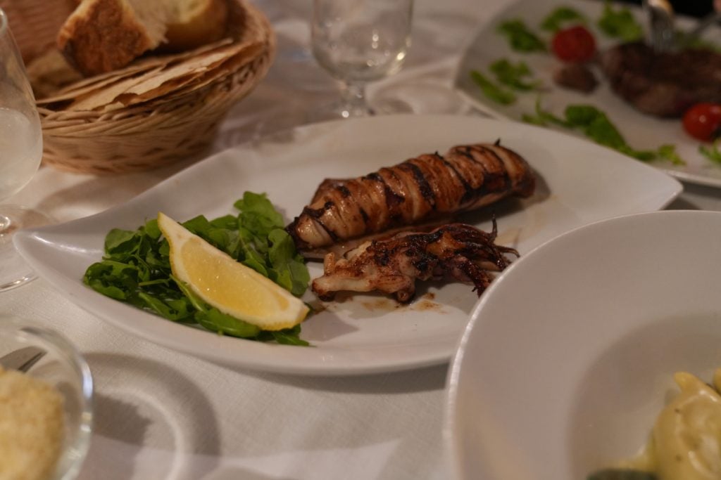 Fresh grilled squid dish at a restaurant in Alghero, Sardinia