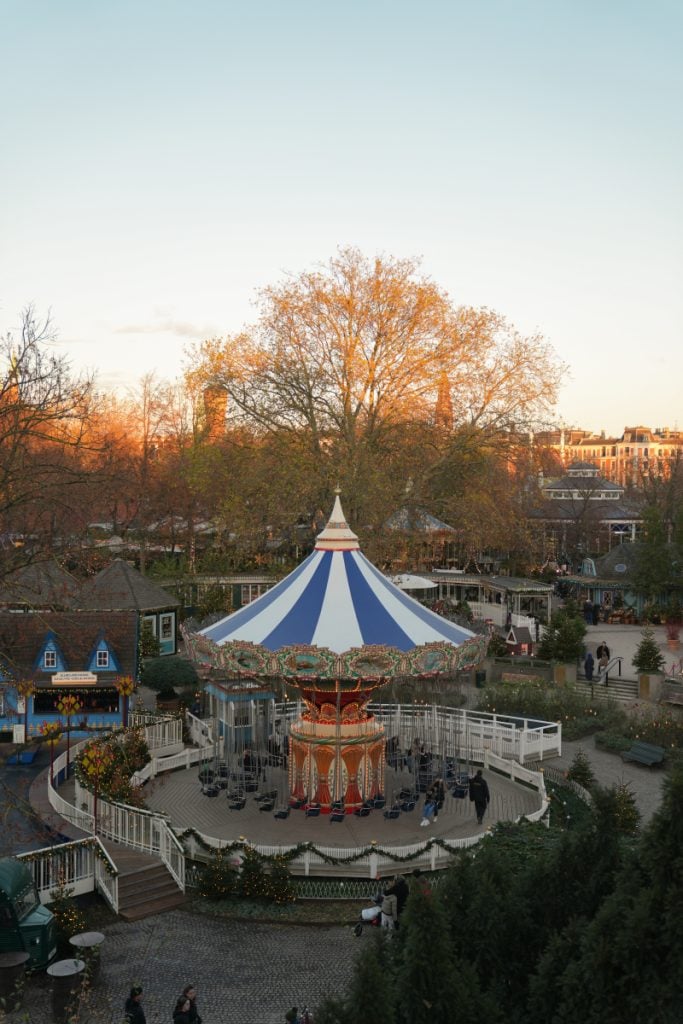 Carousel and striped canopy at Tivoli Gardens in autumn