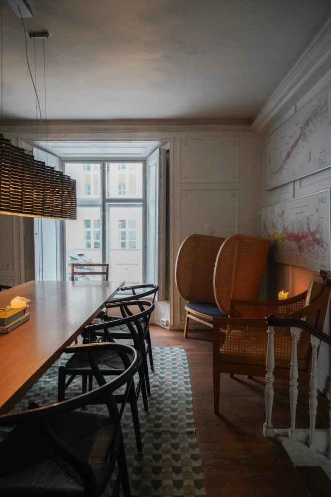 Window-side tables inside Ved Stranden 10 wine bar