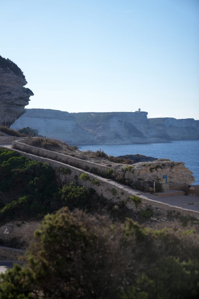 Turquoise water and white limestone cliffs seen from the Bonifacio coastal trail
