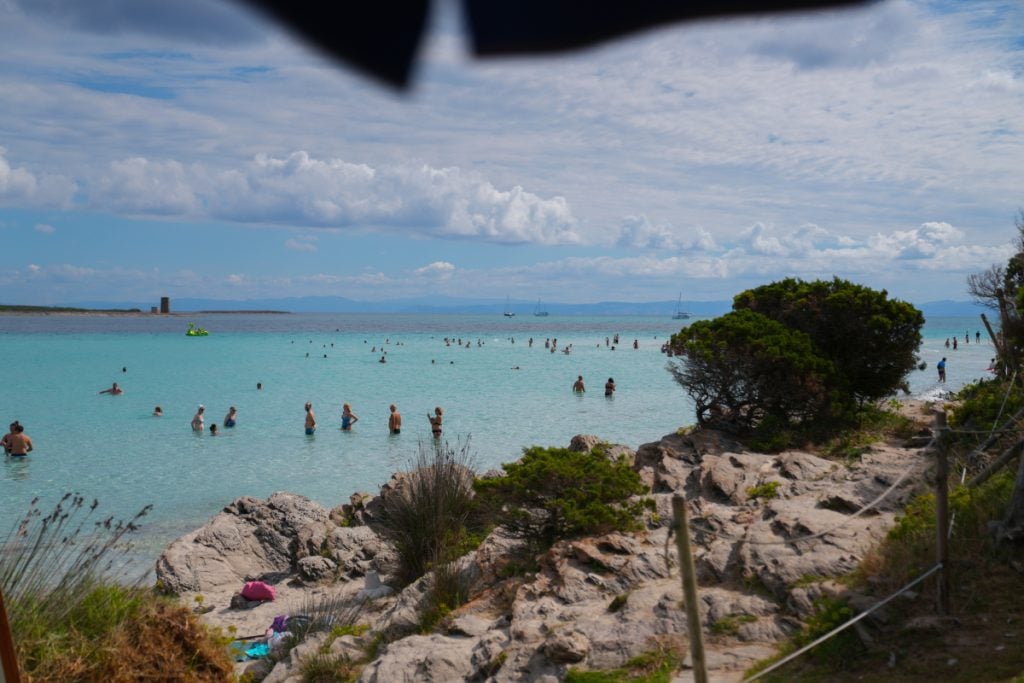 Torre della Pelosa watchtower with turquoise water at La Pelosa beach