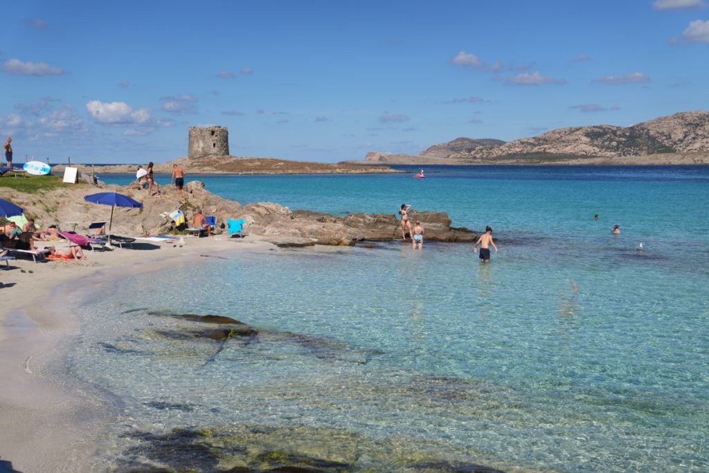 Choppy turquoise water at La Pelosa beach on a windy day