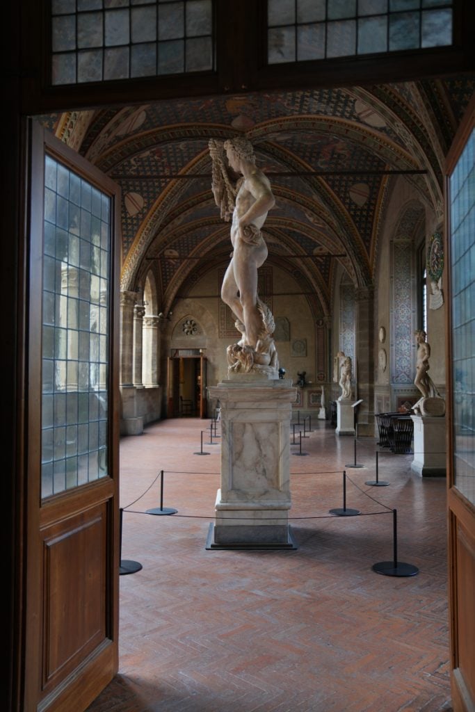 Marble sculpture in an ornate Bargello Museum gallery