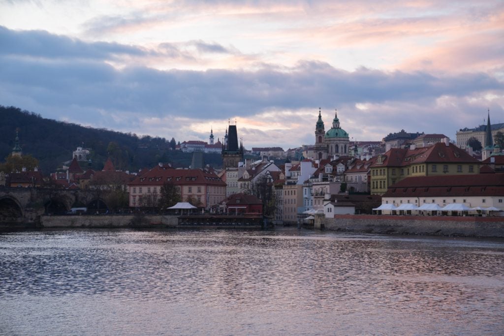 Prague Castle and riverfront across the Vltava at sunset