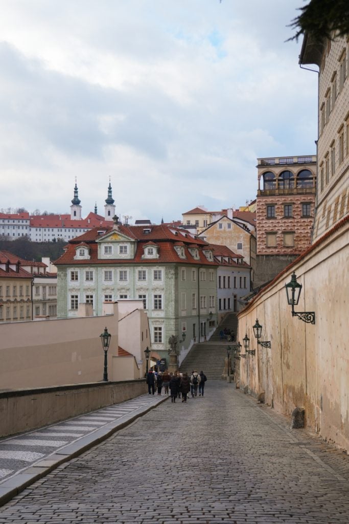 Cobblestone uphill lane leading toward Prague Castle
