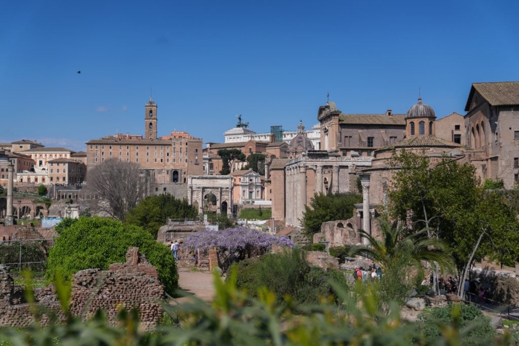 Roman Forum ruins amid greenery in Rome