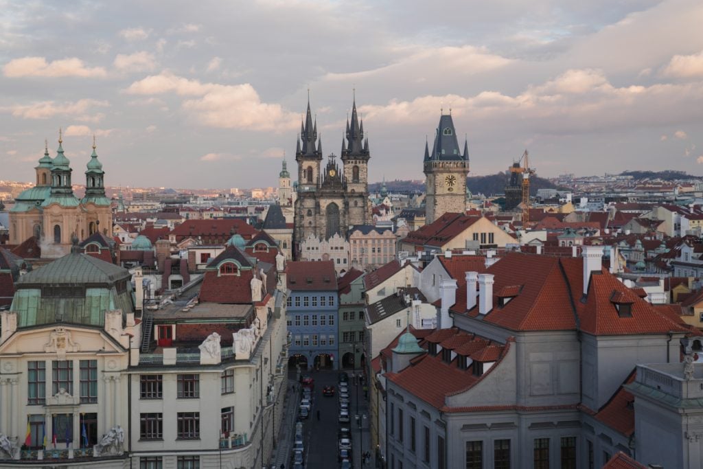 Church spires and red rooftops across Prague's Old Town