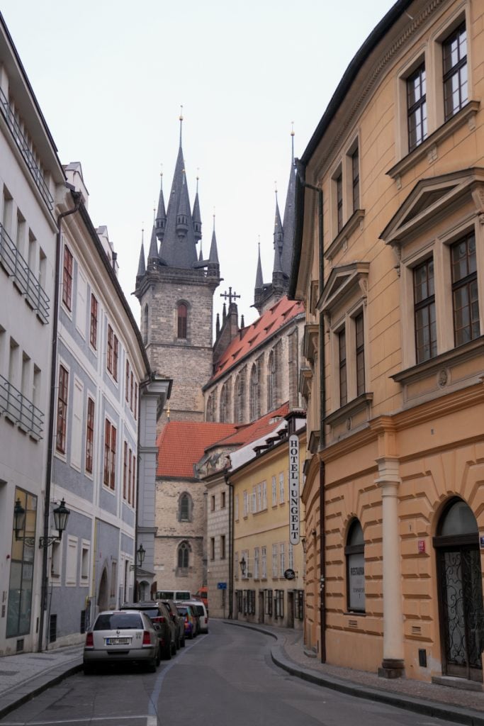 Narrow street and church spires in Prague's Jewish Quarter