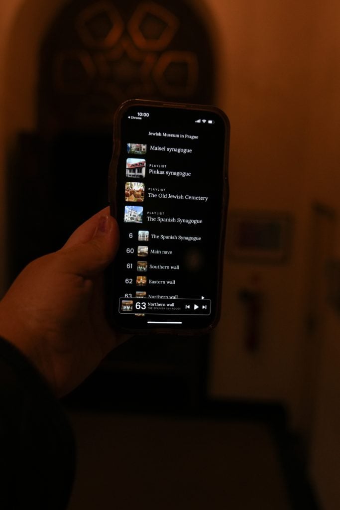 Hand holding a smartphone with the Jewish Town app open