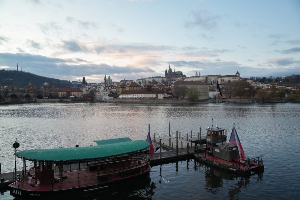 Prague Castle and boats across the Vltava River