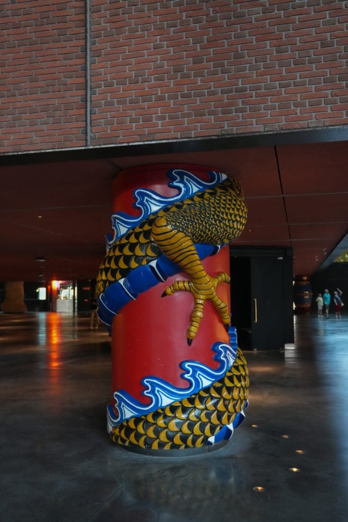 Colorful dragon-wrapped column inside Azkuna Zentroa