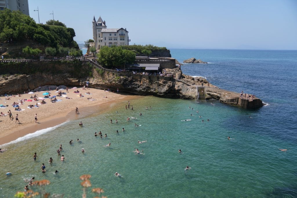 Swimmers in turquoise water at Biarritz's Port Vieux beach