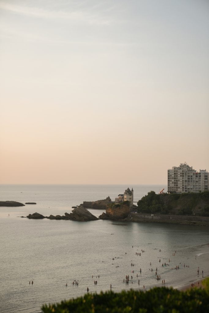 Swimmers along the Biarritz coast at sunset