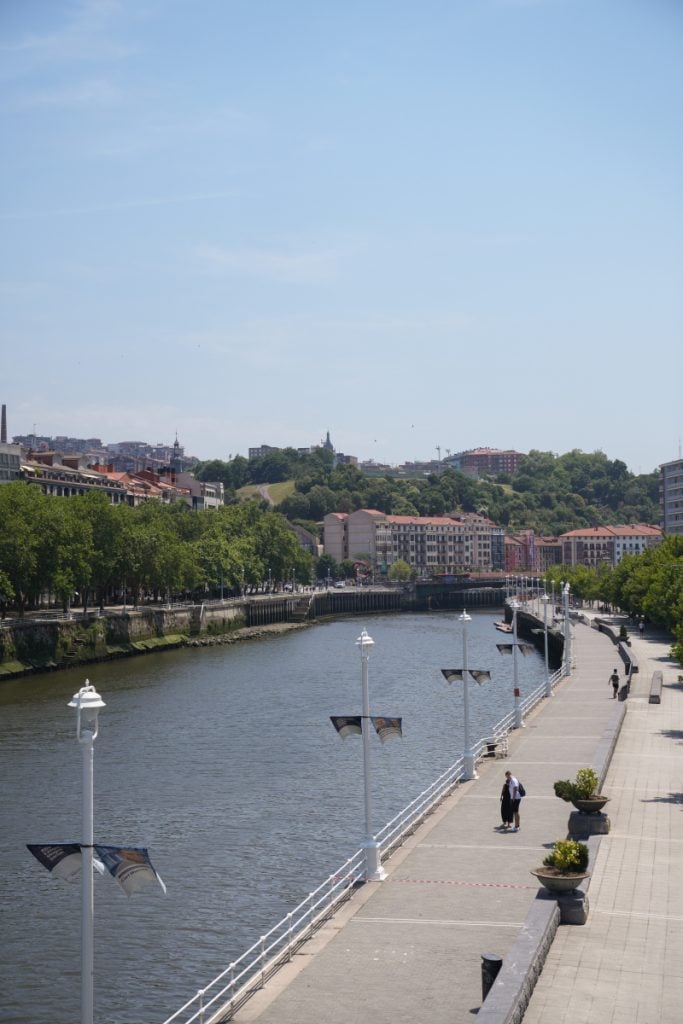 Tree-lined riverside promenade in Bilbao