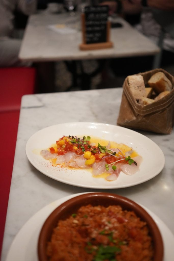 Sliced fish and paella at Chistera & Coquillages