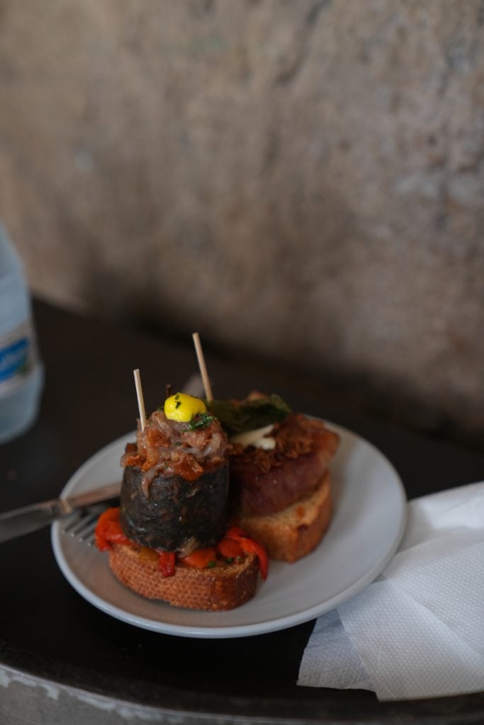 Three pintxos served on a white plate