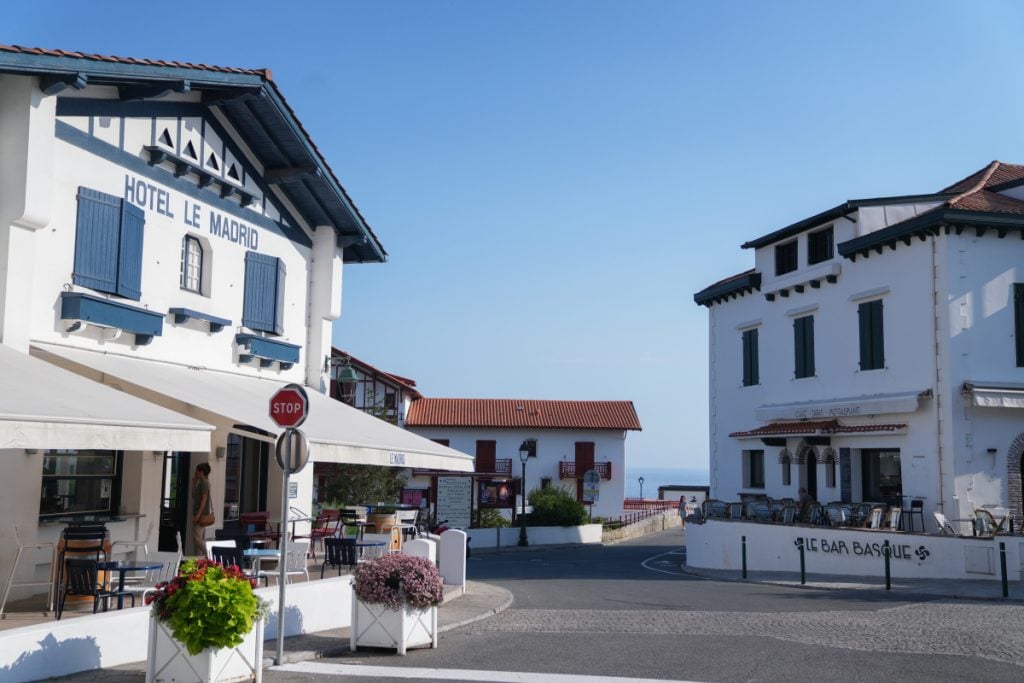 Restaurant terraces along a street toward the sea in Guéthary