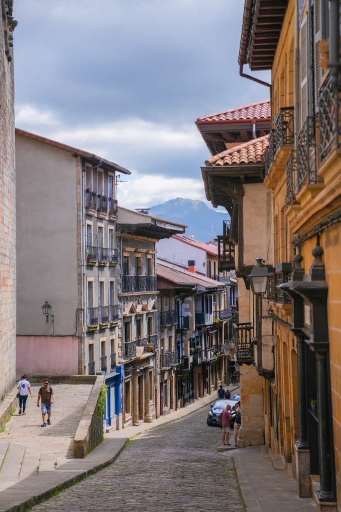 Cobblestone street lined with balconies in Hondarribia's Old Town