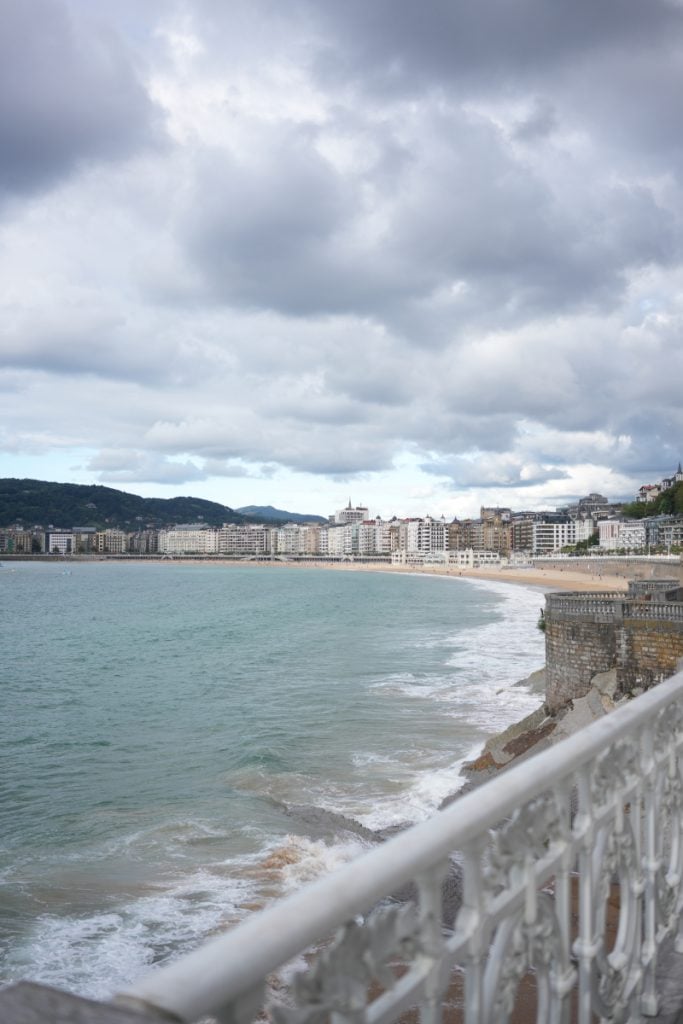 La Concha Bay and San Sebastián waterfront under cloudy skies