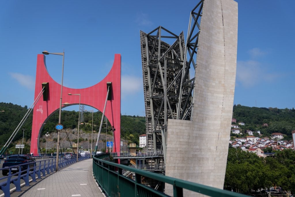 Red arch and walkway of La Salve Bridge