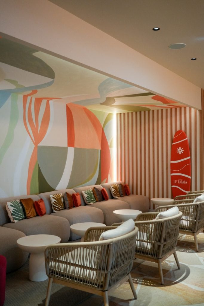 Le Talaia lobby with abstract mural and surfboard