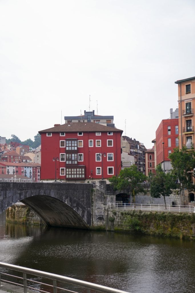 Stone arch bridge over the Nervión River in Bilbao