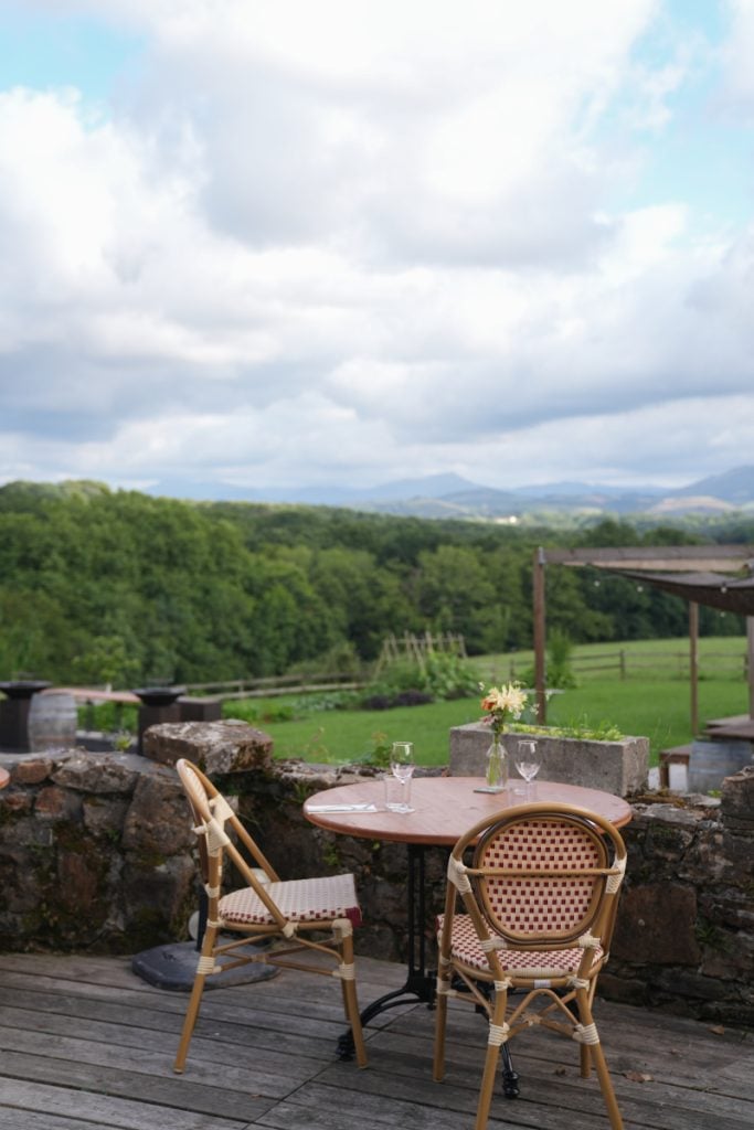Ostalapia patio table overlooking green fields and distant mountains