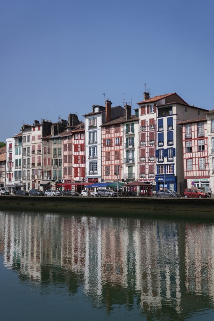 Colorful Bayonne buildings reflected in the river