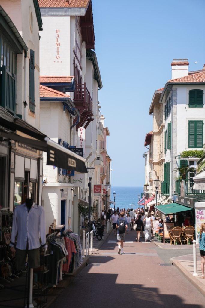Busy shopping street leading to the sea in Biarritz