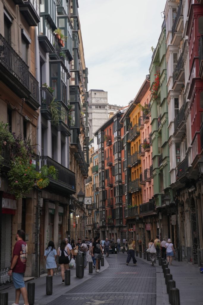 Pedestrians on a colorful street in Bilbao's Old Town