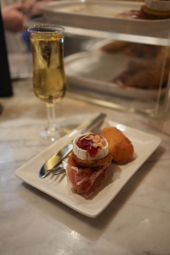 Pintxo, croquette, and sparkling wine at Café Iruña