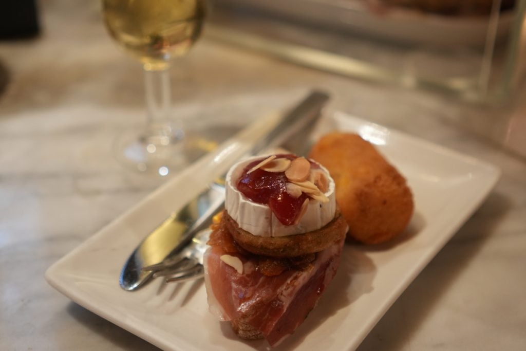 Cheese-topped pintxo and croquette at Café Iruña