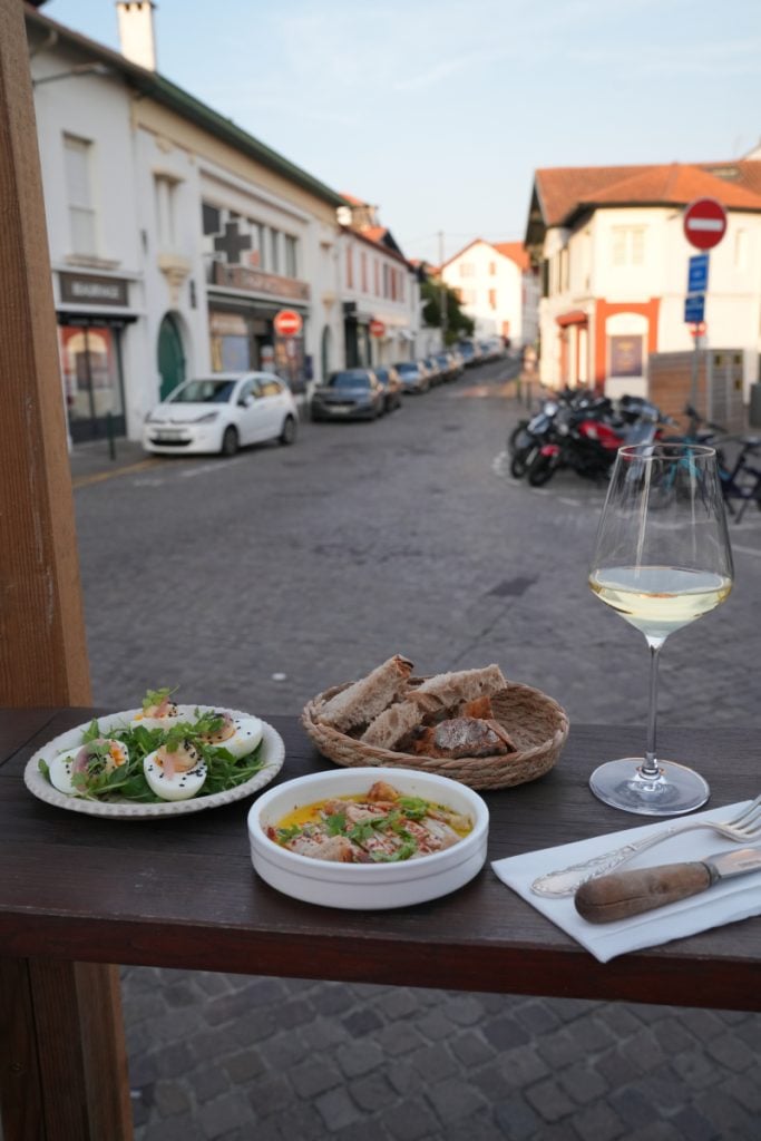 Outdoor table at Cher Bibi with small plates and wine