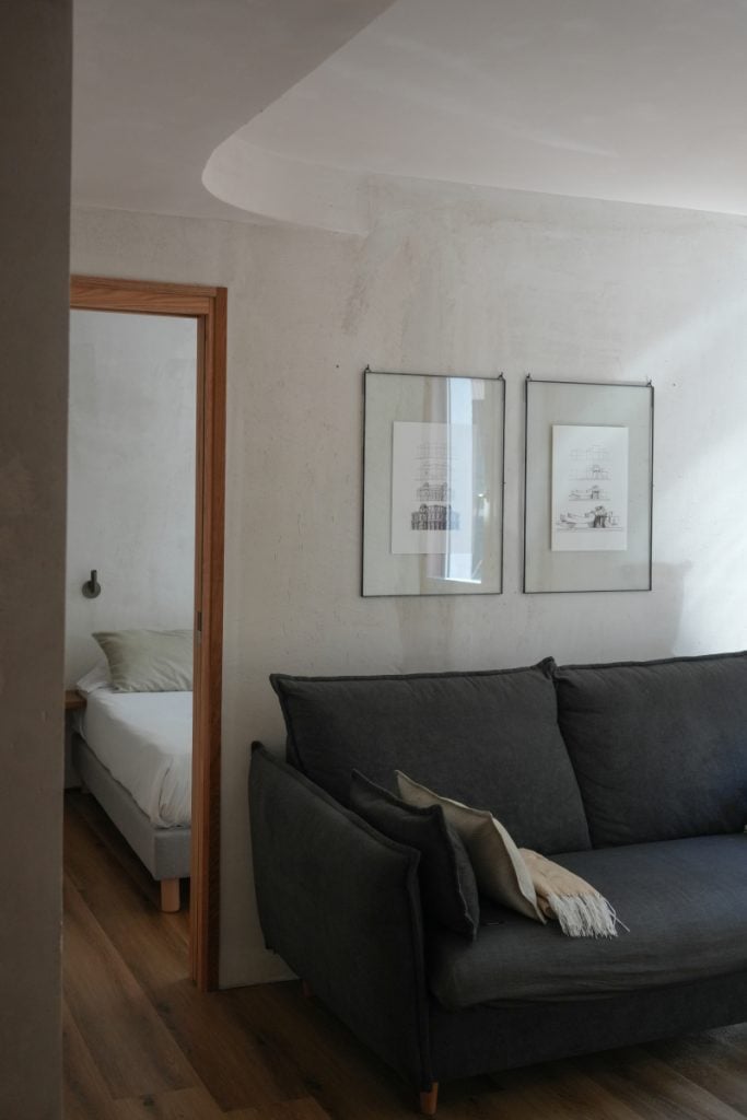 Sofa and bedroom doorway at Enea Living